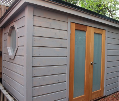 Front left view of a 5' x 10' Urban Studio with grey siding and cedar double doors