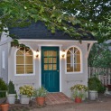 Glen Echo ivory shed 8 x 12 with antique flower boxes and arched door in Overland Park Kansas. ID nu