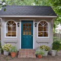 Glen Echo ivory shed 8 x 12 with antique flower boxes and arched door in Overland Park Kansas. ID nu